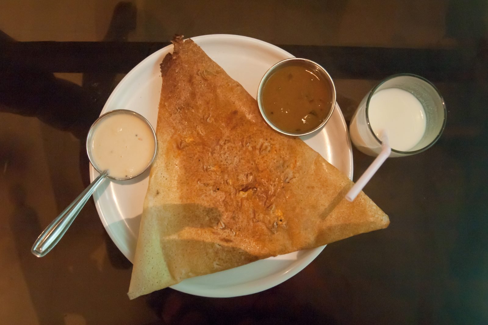 A dosa being cooked on a griddle in Port Blair